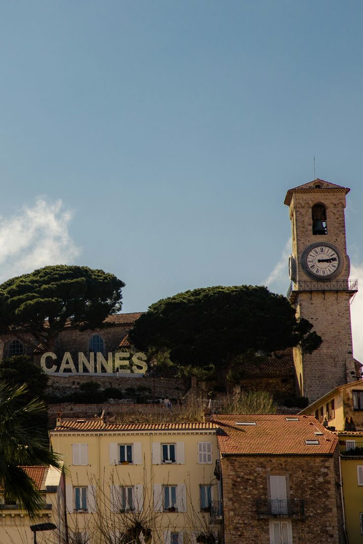 Cannes clock tower and CANNES sign above the rooftops
