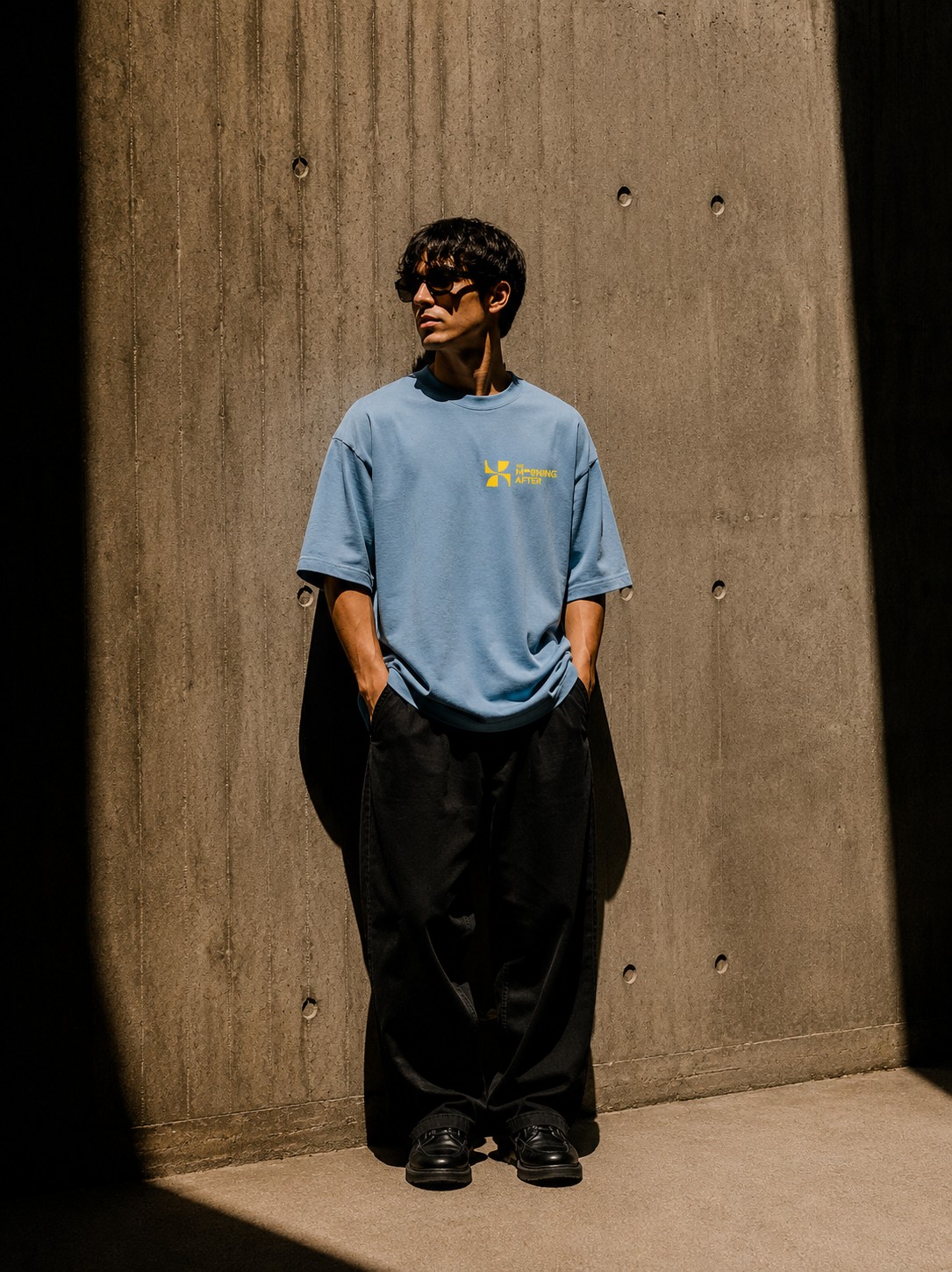 A model in the Summer tee standing in a shaft of coastal light